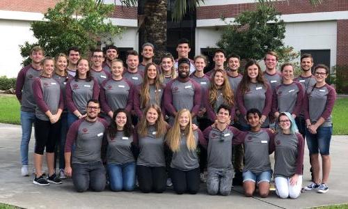 All of Florida Tech's student ambassadors standing together in front of Skurla Hall on campus